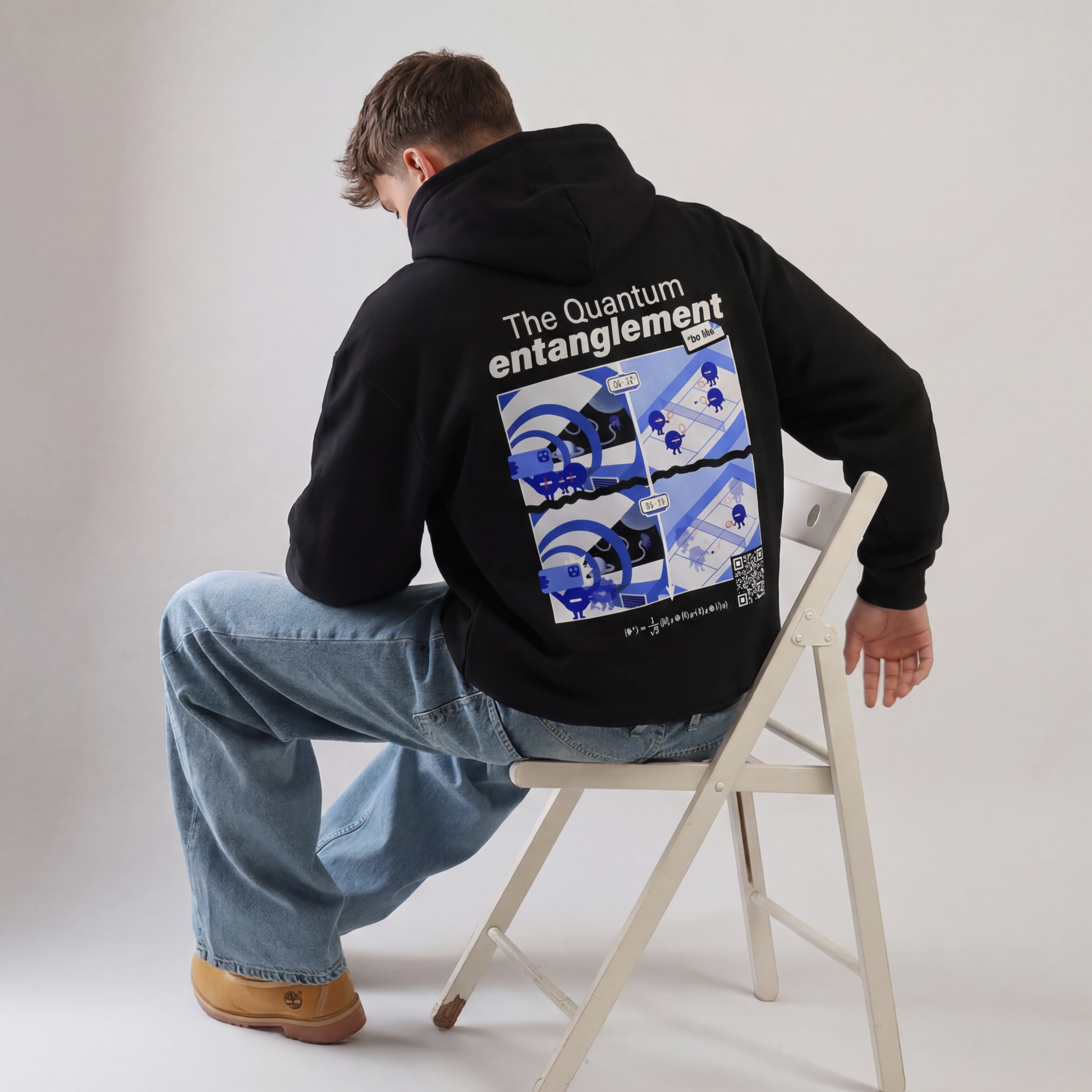 Black quantum entanglement hoodie back view. EigenMode physics streetwear with comic-style illustration, Bell state equation and QR code, men's oversized fit, studio shot