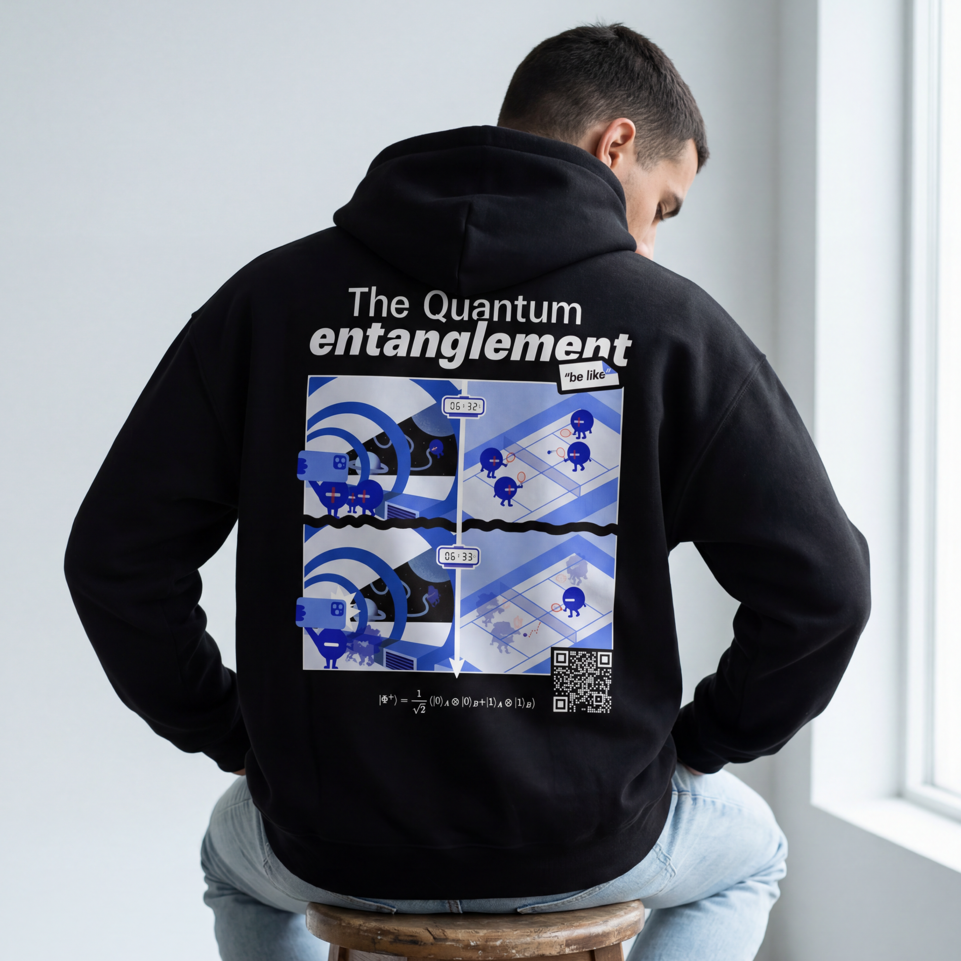 Black oversized hoodie with quantum entanglement illustration. EigenMode physics clothing, back view in studio, comic-style graphic with |Φ⁺⟩ Bell state equation and scannable QR code
