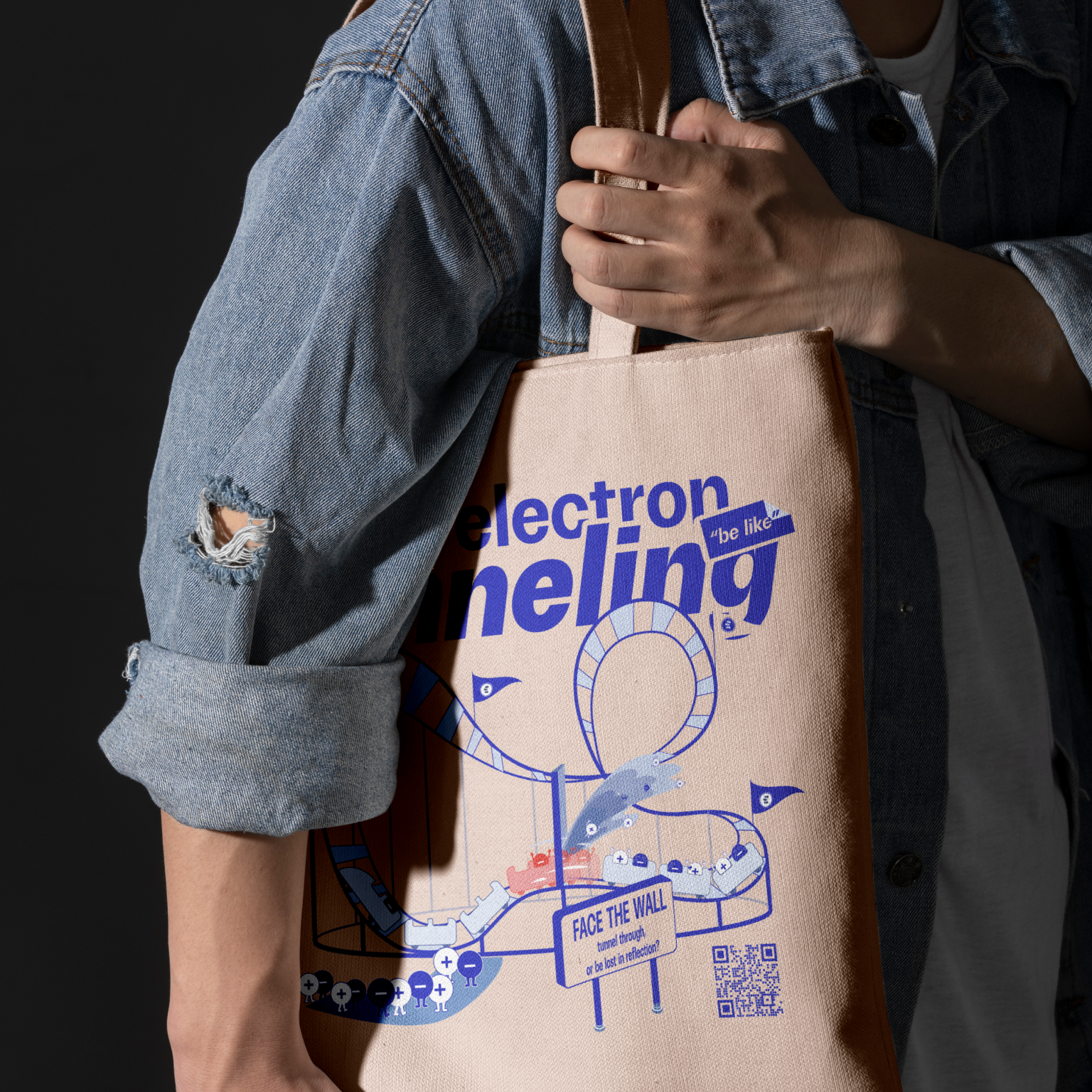 White tote bag with the electron tunneling illustration, quantum physics-inspired accessory, person wering jean jacket