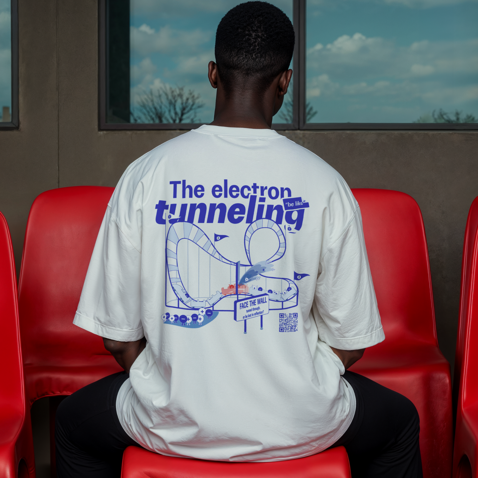 Back view of T-shirt featuring the electron tunneling effect design, modern quantum physics clothing, red chair background
