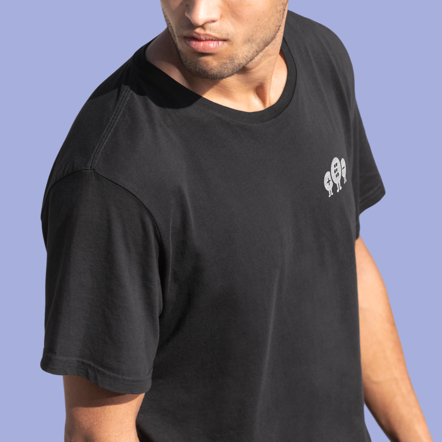 Man wearing a black t-shirt with quantum tryon embrodery on a blue background